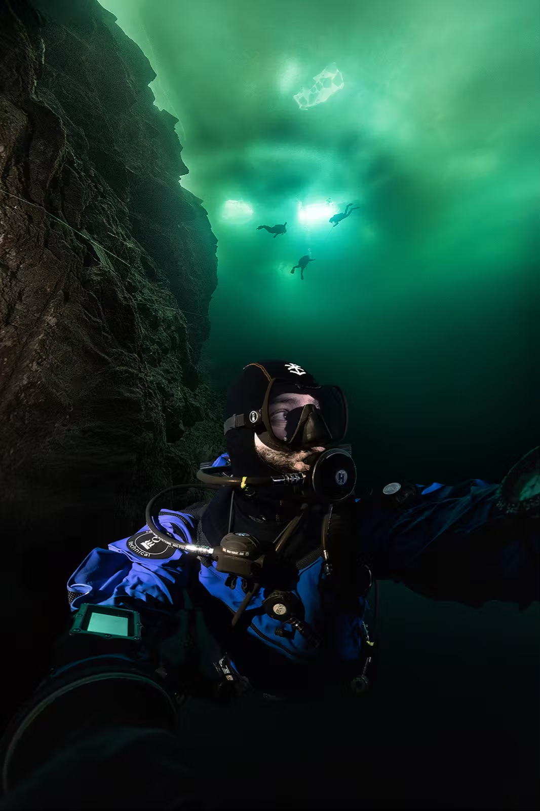 Underwater portrait of Imad Farhat ice diving at Morrison Quarry Canada with team above
