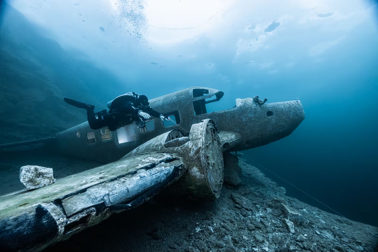 Tech diver inspecting sunken aircraft wreck at Morrison Quarry Canada flooded quarry